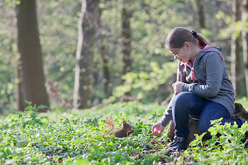 Image showing Little girl and squirrel