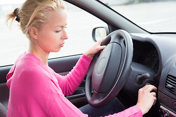 Image showing Female car driver starting the engine.