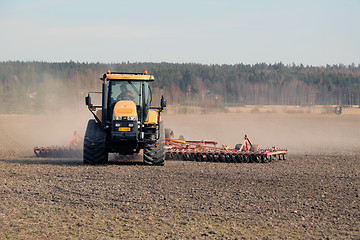 Image showing Farmer Cultivating Field with Caterpillar Challenger Tractor and