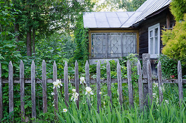 Image showing old country house with porch and rustic wood fence 