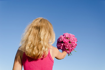 Image showing back view of woman and hand with peony bouquet 