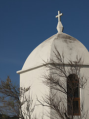 Image showing Small white chapel by a tree with blue sky