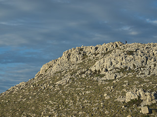 Image showing climber in the distance, climbing the hill