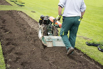 Image showing Man rototilling the ground 