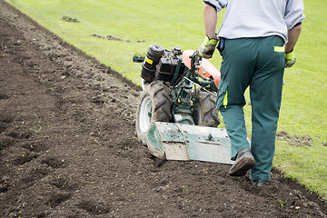 Image showing Man with rototiller