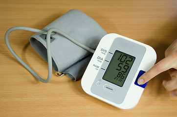 Image showing measuring blood pressure finger on start button