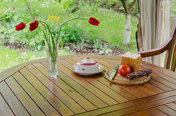 Image showing smoked sausage white bread butter and flowers 