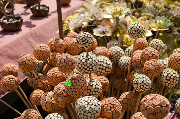 Image showing handmade wooden and clay balls ornaments on stick  