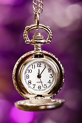 Image showing silver retro clock on a festive purple background