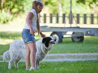 Image showing Little girl with dog