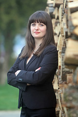 Image showing Business woman posing with wood