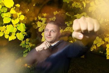 Image showing Man in autumn park with fighting pose