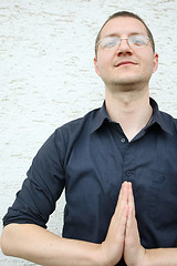 Image showing A man in a shirt with a namaste greeting