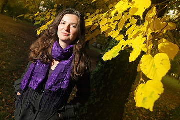 Image showing Happy brunette in autumn park 