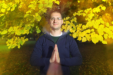 Image showing Young man with namaste greeting