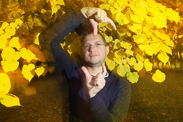 Image showing Man in autumn park with strange pose