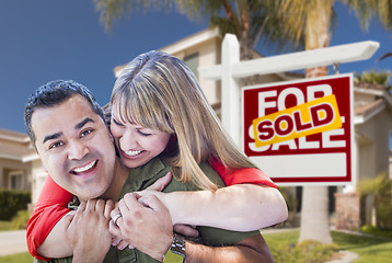 Image showing Couple in Front of Sold Real Estate Sign and House