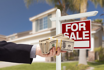 Image showing Buyer Handing Over Cash for House with For Sale Sign