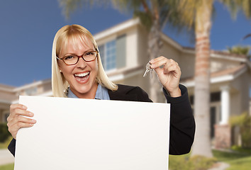 Image showing Excited Woman Holding House Keys and Blank Real Estate Sign