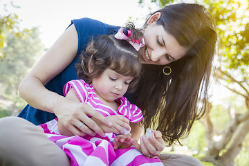 Image showing Young Mother and Cute Baby Girl Applying Fingernail Polish