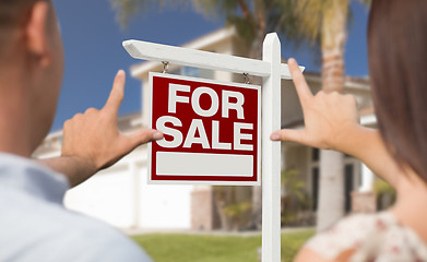 Image showing For Sale Sign, House and Military Couple Framing Hands