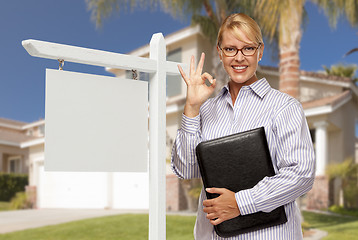 Image showing Real Estate Agent in Front of Blank Sign and House