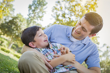 Image showing Loving Father Tickling Son in the Park