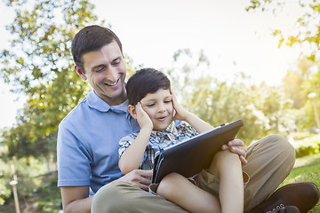 Image showing Handsome Mixed Race Father and Son Playing on Computer Tablet