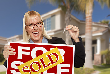 Image showing Excited Woman Holding House Keys and Sold Real Estate Sign