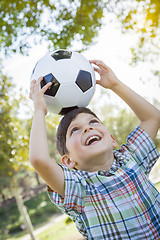 Image showing Cute Young Boy Playing with Soccer Ball in Park