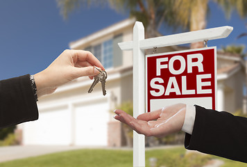 Image showing Agent Handing Over House Keys in Front of New Home