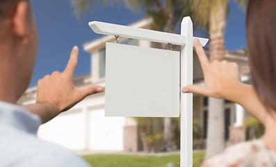 Image showing Blank Real Estate Sign, House and Military Couple Framing Hands