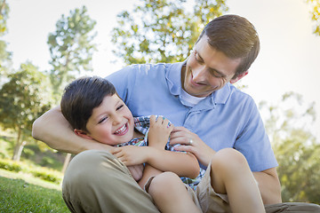 Image showing Loving Father Tickling Son in the Park