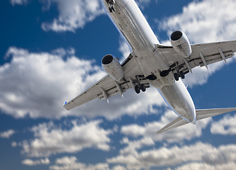 Image showing Jet Airplane Landing with Dramatic Clouds Behind