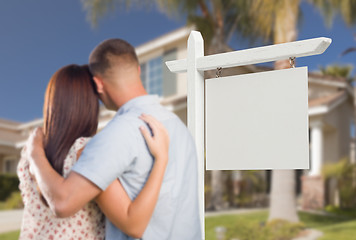 Image showing Blank Real Estate Sign and Military Couple Looking at House