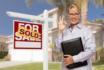 Image showing Real Estate Agent in Front of Sold Sign and House