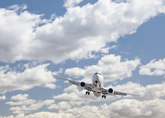 Image showing Jet Airplane Landing with Dramatic Clouds Behind