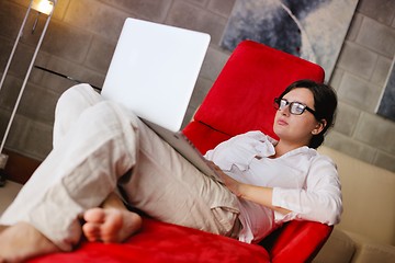 Image showing woman using a laptop computer at home