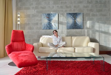 Image showing happy young woman relax at home on sofa