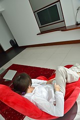 Image showing happy young woman relax at home on sofa