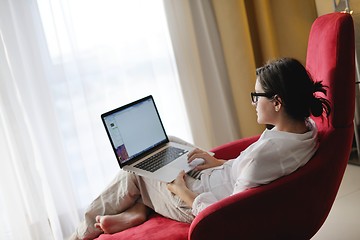 Image showing woman using a laptop computer at home