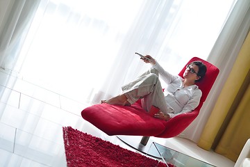 Image showing happy young woman relax at home on sofa