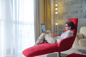 Image showing woman using a laptop computer at home