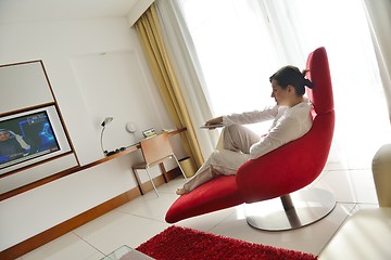 Image showing happy young woman relax at home on sofa