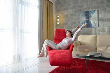 Image showing happy young woman relax at home on sofa