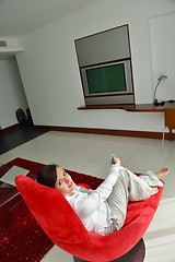 Image showing happy young woman relax at home on sofa