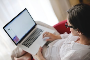 Image showing woman using a laptop computer at home