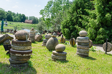 Image showing millstones stone figure in meadow landscape park  