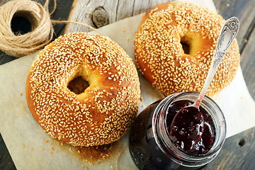 Image showing Homemade bagels and lingonberry jam closeup. 