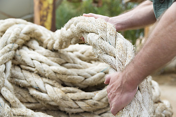 Image showing Hands pulling rope